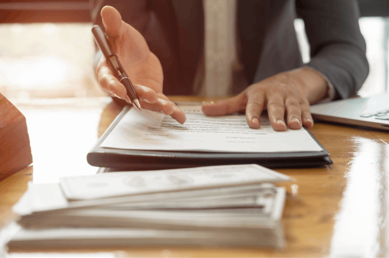 Scrivania con sopra un contratto di affitto transitorio pronto per la firma